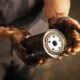 Mechanic holding a used oil filter with oil stains 80x80