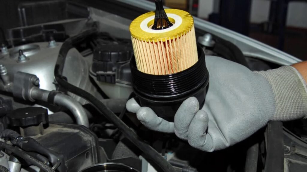 Mechanic replacing oil filter element