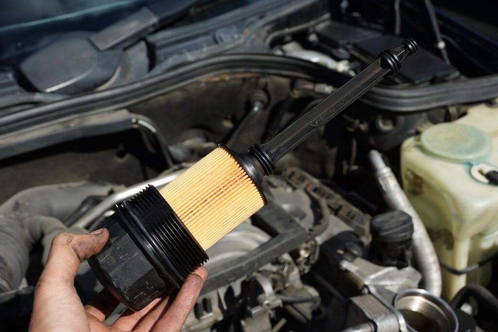 Oil filter being replaced in car